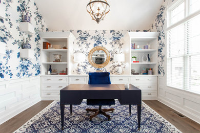 Home office - mid-sized transitional freestanding desk medium tone wood floor, vaulted ceiling and wallpaper home office idea in Atlanta