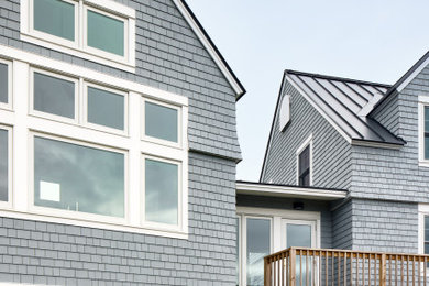 Example of a beach style home design design in Portland Maine