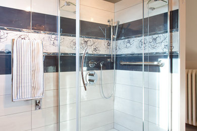 This is an example of a large arts and crafts master bathroom in Toronto with a corner shower, white tile, ceramic tile, white walls, porcelain floors, white cabinets, an integrated sink and granite benchtops.