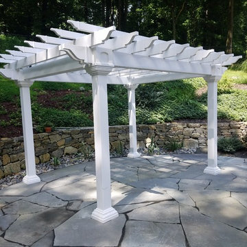 Backyard irregular patio with pergola and lighting