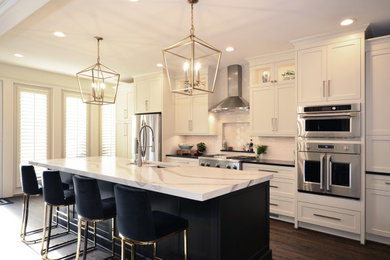 Large transitional single-wall dark wood floor and brown floor open concept kitchen photo in Charlotte with a single-bowl sink, shaker cabinets, white cabinets, quartz countertops, beige backsplash, subway tile backsplash, stainless steel appliances, an island and beige countertops