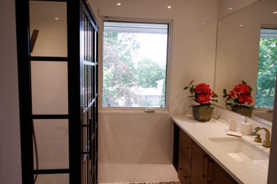 Inspiration for a small contemporary master white tile and ceramic tile ceramic tile, multicolored floor and single-sink walk-in shower remodel in Ottawa with flat-panel cabinets, medium tone wood cabinets, a one-piece toilet, white walls, an undermount sink, quartz countertops, a hinged shower door, white countertops and a floating vanity