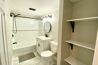 Example of a mid-sized minimalist master single-sink tub/shower combo design in Toronto with white cabinets, beige walls, white countertops and a freestanding vanity