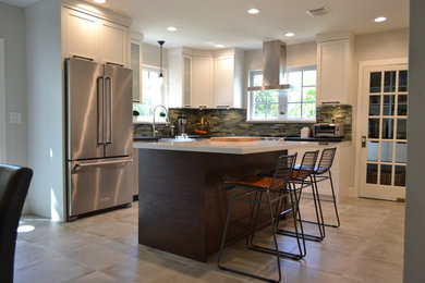 Eat-in kitchen - large farmhouse l-shaped porcelain tile and gray floor eat-in kitchen idea in Miami with a farmhouse sink, shaker cabinets, white cabinets, granite countertops, blue backsplash, glass tile backsplash, stainless steel appliances and an island