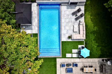 Transitional backyard stone pool photo in Toronto