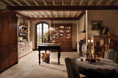 Inspiration for a mid-sized rustic galley limestone floor eat-in kitchen remodel in Chicago with a farmhouse sink, shaker cabinets, beige cabinets, stainless steel appliances and an island