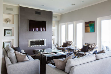 Design ideas for a beach style formal living room in Houston with grey walls, a ribbon fireplace and a wall-mounted tv.