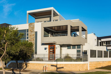 Photo of an expansive contemporary two-storey house exterior in Perth with a flat roof and a metal roof.