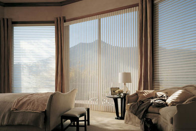 Example of a carpeted bedroom design in San Diego with beige walls
