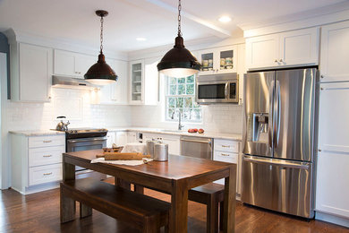 Open concept kitchen - large country l-shaped medium tone wood floor and brown floor open concept kitchen idea in Detroit with an undermount sink, shaker cabinets, white cabinets, granite countertops, white backsplash, subway tile backsplash, stainless steel appliances and no island