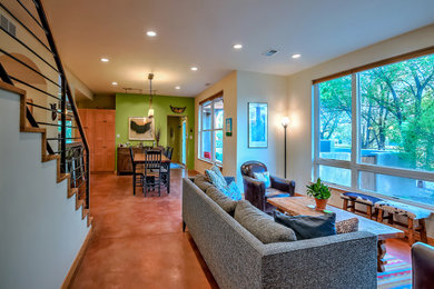 Great room - mid-sized southwestern concrete floor and multicolored floor great room idea in Albuquerque with multicolored walls and a wood stove