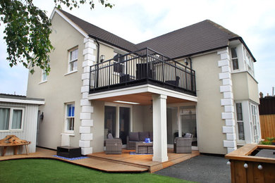 Inspiration for a beige classic two floor render detached house in Other with a pitched roof and a tiled roof.