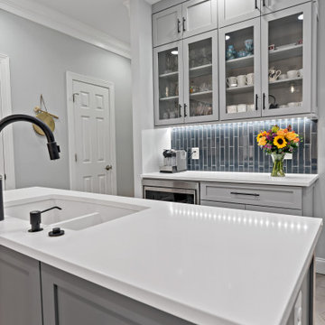 White Island with Matte Black Fixtures in Modern Kitchen