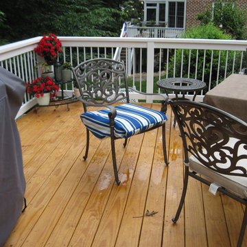 Decking fastened with screws, white stained rail