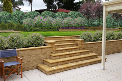 Design ideas for a large mediterranean backyard partial sun formal garden for summer in Adelaide with natural stone pavers.