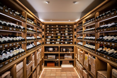 This is an example of a medium sized classic wine cellar in Sussex.