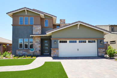 Photo of a large transitional two-storey green exterior in Phoenix with stone veneer.