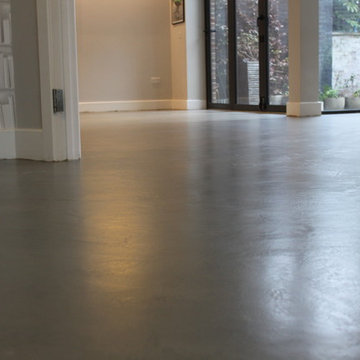Polished concrete floor in bronze colour over existing floor tiles London