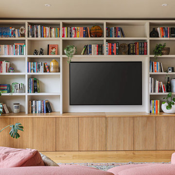 Living room with bespoke bookcase storage wall