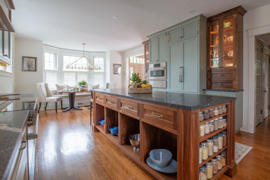 Mid-sized elegant u-shaped eat-in kitchen photo in Philadelphia with beaded inset cabinets, green cabinets, quartzite countertops, multicolored backsplash, marble backsplash, an island and black countertops