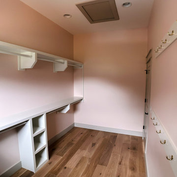 Elegant Guest Closet Organization: White Built-Ins, Open Cubbies, and Hanging St