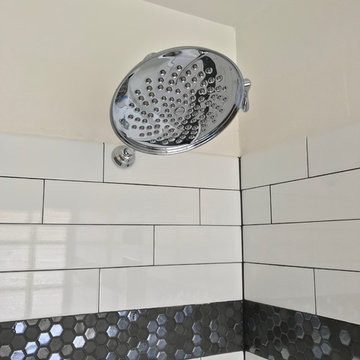 Main bathroom remodel with floor tile and baseboard trim work