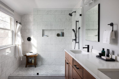 Large transitional master gray tile and marble tile marble floor, gray floor and double-sink bathroom photo in DC Metro with shaker cabinets, brown cabinets, a one-piece toilet, gray walls, an undermount sink, quartz countertops, white countertops, a niche and a built-in vanity