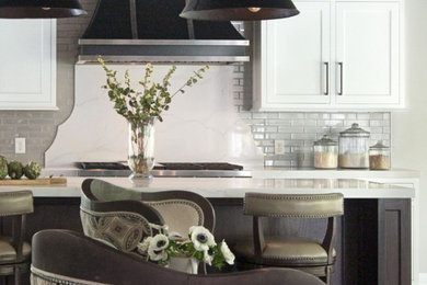 Inspiration for a large contemporary l-shaped medium tone wood floor and gray floor open concept kitchen remodel in St Louis with a farmhouse sink, flat-panel cabinets, white cabinets, quartz countertops, gray backsplash, glass tile backsplash, paneled appliances, an island and white countertops