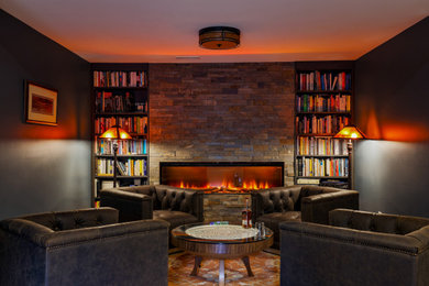 Example of an eclectic multicolored floor family room design in DC Metro with black walls, a ribbon fireplace and a stacked stone fireplace