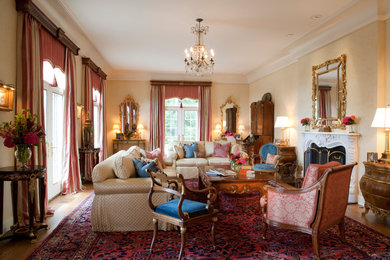 Huge tuscan formal medium tone wood floor living room photo in Chicago with no tv, yellow walls, a standard fireplace and a stone fireplace