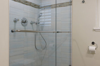 Small beach style 3/4 blue tile and ceramic tile ceramic tile double shower photo in Vancouver with flat-panel cabinets, white cabinets, a wall-mount toilet, beige walls and a wall-mount sink