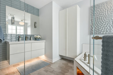 Large trendy kids' blue tile and ceramic tile porcelain tile bathroom photo in Montreal with flat-panel cabinets, white cabinets, a wall-mount toilet, blue walls, an integrated sink and solid surface countertops