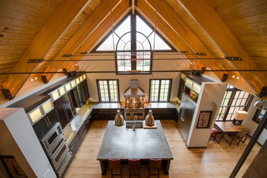 Inspiration for a large contemporary u-shaped light wood floor open concept kitchen remodel in Other with an undermount sink, flat-panel cabinets, dark wood cabinets, stainless steel appliances and an island