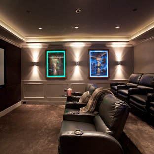 Photo of a large traditional enclosed home cinema in Vancouver with brown walls, ceramic flooring, a projector screen and brown floors.