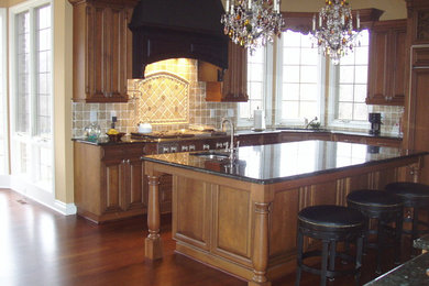Large elegant single-wall eat-in kitchen photo in Detroit with flat-panel cabinets, medium tone wood cabinets, granite countertops and an island
