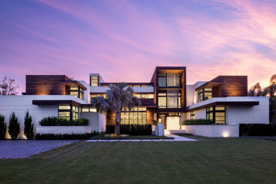 Diseño de fachada de casa blanca moderna grande de dos plantas con revestimiento de estuco y tejado plano