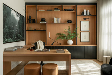 Study room - small contemporary built-in desk light wood floor and brown floor study room idea in DC Metro with white walls