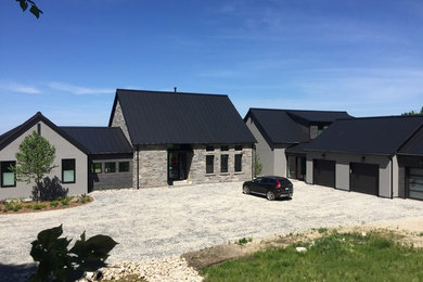 Inspiration for a contemporary gray one-story stone gable roof remodel in Toronto