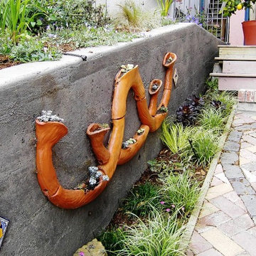 Front Yard with Artistic Driveway, Custom Sculptures, Planted Walls