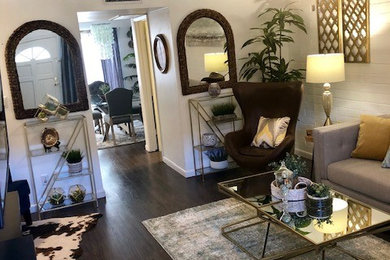 Mid-sized trendy enclosed laminate floor and gray floor living room photo in Phoenix with white walls
