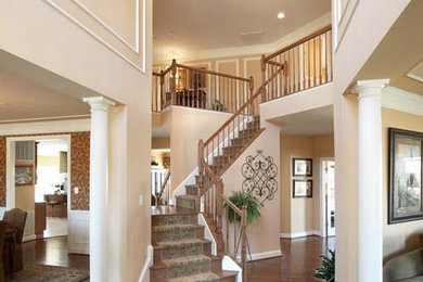 Large elegant carpeted l-shaped staircase photo in Cleveland with wooden risers