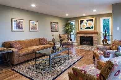 This is an example of a large traditional open concept living room in Chicago with beige walls, dark hardwood floors and a standard fireplace.