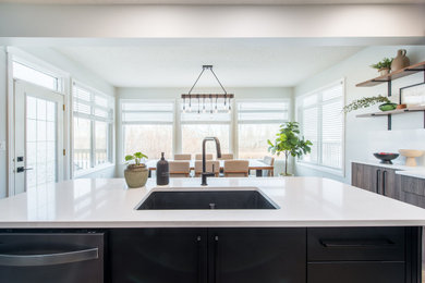 Example of a transitional galley vinyl floor and brown floor eat-in kitchen design in Edmonton with an undermount sink, flat-panel cabinets, medium tone wood cabinets, quartzite countertops, white backsplash, quartz backsplash, stainless steel appliances, an island and white countertops