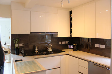 This is an example of a small modern u-shaped enclosed kitchen in London with a built-in sink, flat-panel cabinets, white cabinets, quartz worktops, brown splashback, glass sheet splashback, stainless steel appliances, porcelain flooring and an island.