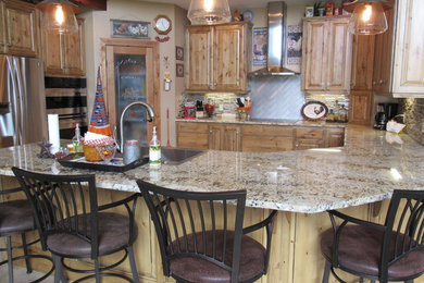 Inspiration for a cottage u-shaped ceramic tile and beige floor kitchen remodel in Denver with a drop-in sink, raised-panel cabinets, medium tone wood cabinets, granite countertops, multicolored backsplash, stainless steel appliances, matchstick tile backsplash and a peninsula