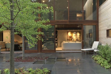 Inspiration for a large modern courtyard patio fountain remodel in San Diego with no cover