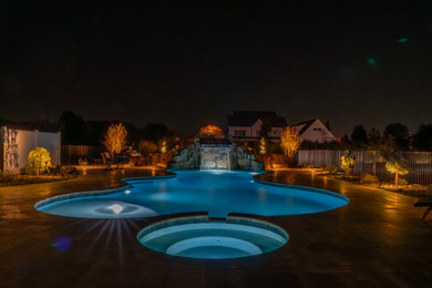 Стильный дизайн: большой естественный бассейн произвольной формы на заднем дворе в морском стиле с джакузи и покрытием из каменной брусчатки - последний тренд