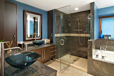Large contemporary master bathroom in Minneapolis with a vessel sink, flat-panel cabinets, dark wood cabinets, granite benchtops, a drop-in tub, a double shower, beige tile, mosaic tile, blue walls and mosaic tile floors.