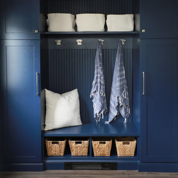 coastal navy mudroom with hooks and baskets