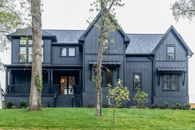 Inspiration for a black two-story mixed siding and board and batten house exterior remodel in Nashville with a shingle roof and a black roof